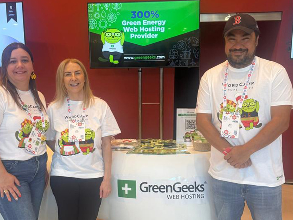 The GreenGeeks team standing at the booth